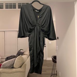 Black wrap dress with sleeves. NWT. Size small but could fit a medium
